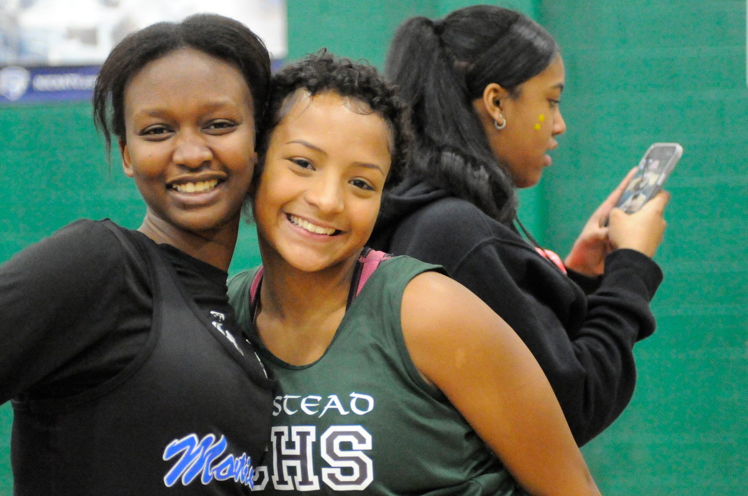 Taking a break. The Homestead School’s Ayana Banks, right, strikes a pose in between events with a runner from Monticello.